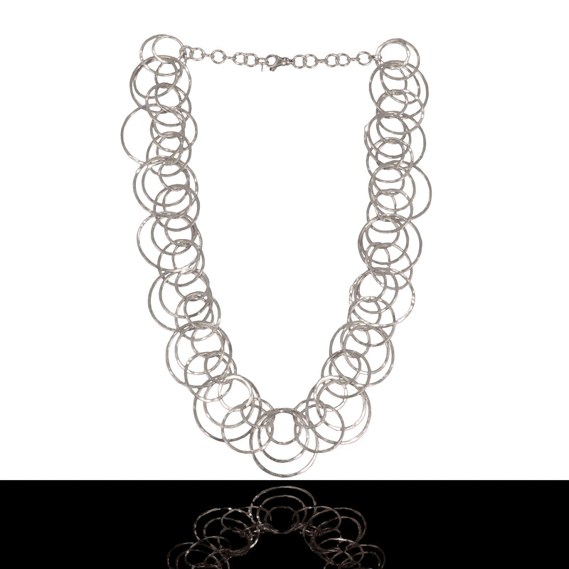 Statement necklace handcrafted from dozens of hammered rings of Argentium sterling silver.