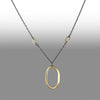 Large 14K yellow gold pendant on an oxidized sterling silver rolo chain highlighted by four smaller 14K gold links.