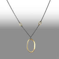 Large 14K yellow gold pendant on an oxidized sterling silver rolo chain highlighted by four smaller 14K gold links.