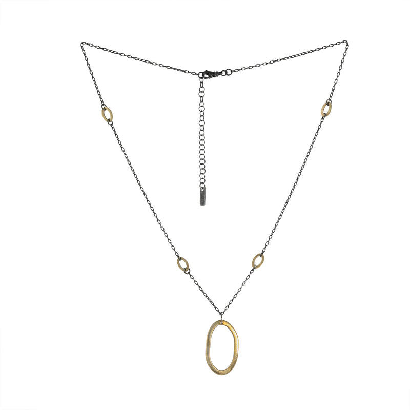 Large 14K yellow gold pendant on an oxidized sterling silver rolo chain highlighted by four smaller 14K gold links.