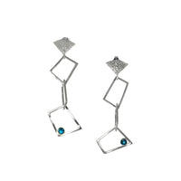 Contemporary trapezoid dangle earrings, handcrafted from Argentium and sterling silver and set with London blue topaz stones. 