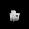 Contemporary sterling silver wrap ring with 14k gold elements and a 4mm London blue topaz set in 14k gold.