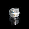 Contemporary sterling silver wrap ring with 14k gold elements and a 4mm London blue topaz set in 14k gold.