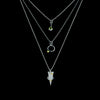 Oxidized argentium sterling silver and 18K gold charm pendant necklace with contemporary geometric styling. Shown in a layered look.