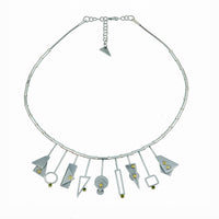 Contemporary, geometric statement necklace handcrafted in sterling silver with 18K gold and peridot accents.