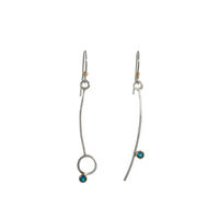 Asymmetric drop earrings handcrafted from Argentium sterling silver and London Blue topaz gemstones set in 18k gold bezels. Silver ear wires accented with 18k gold elements. 