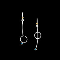 Asymmetric drop earrings handcrafted from Argentium sterling silver and London Blue topaz gemstones set in 18k gold bezels. Silver ear wires accented with 18k gold elements. 