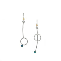 Asymmetric drop earrings handcrafted from Argentium sterling silver and London Blue topaz gemstones set in 18k gold bezels. Silver ear wires accented with 18k gold elements. 