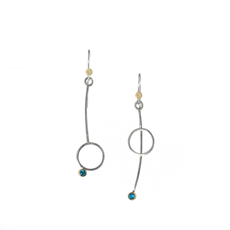 Asymmetric drop earrings handcrafted from Argentium sterling silver and London Blue topaz gemstones set in 18k gold bezels. Silver ear wires accented with 18k gold elements. 