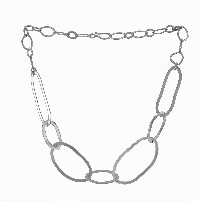 Tangled rings of Argentium sterling silver handcrafted into a chain necklace with a modern, organic design.