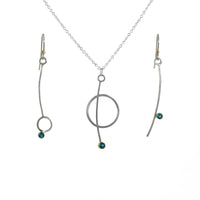 Contemporary pendant necklace handcrafted from Argentium sterling silver with a London Blue topaz set in 18k yellow gold.  Shown with matching earrings.