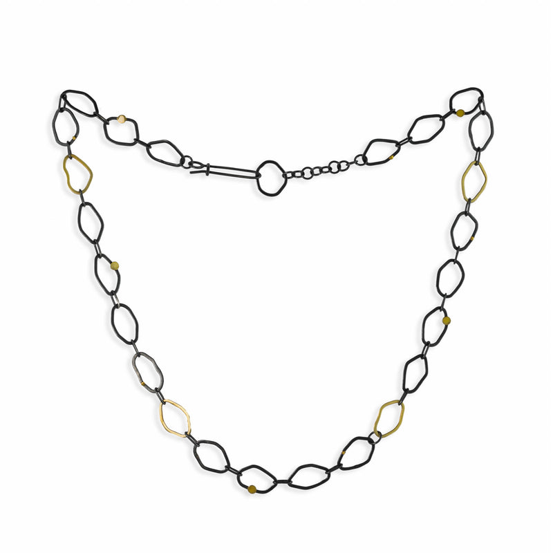 Contemporary, chain necklace handcrafted from organically shaped links of oxidized Argentium sterling silver interspersed with 18K yellow gold links and elements.