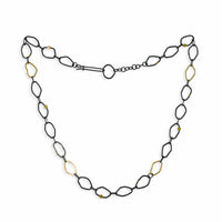 Contemporary, chain necklace handcrafted from organically shaped links of oxidized Argentium sterling silver interspersed with 18K yellow gold links and elements.