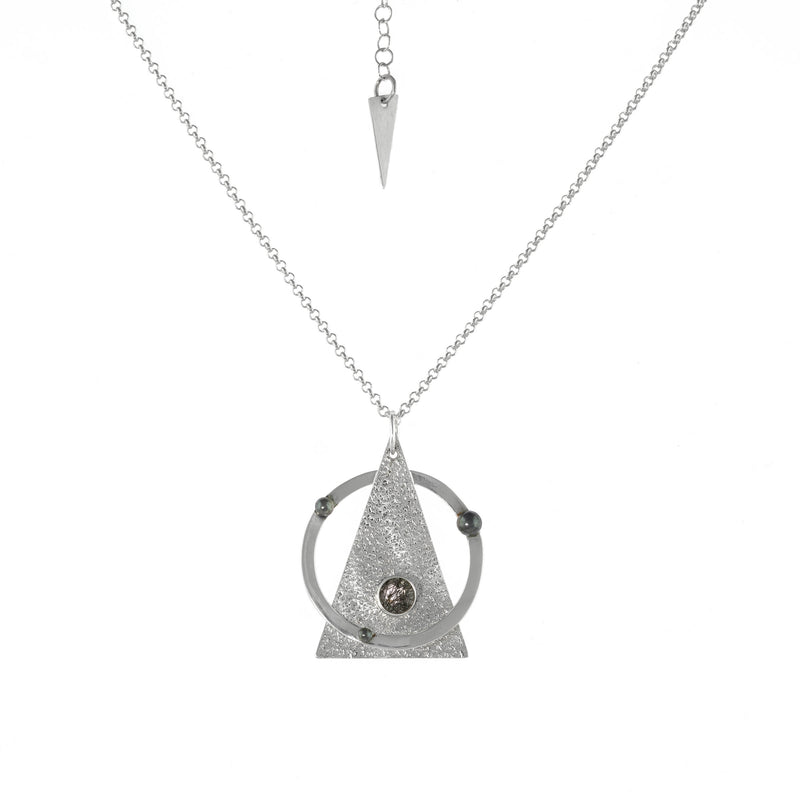 Contemporary pendant necklace handcrafted from Argentium sterling silver highlighted with oxidized silver “pearls” and set with a black tourmalinated quartz stone on a silver chain.