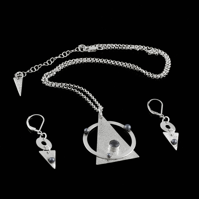 Contemporary pendant necklace handcrafted from Argentium sterling silver highlighted with oxidized silver “pearls” and set with a black tourmalinated quartz stone on a silver chain.