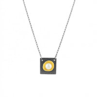 Contemporary pendant necklace handcrafted from oxidized Argentium and sterling silver highlighted with a freshwater pearl in an18K gold cup.  Silver chain.