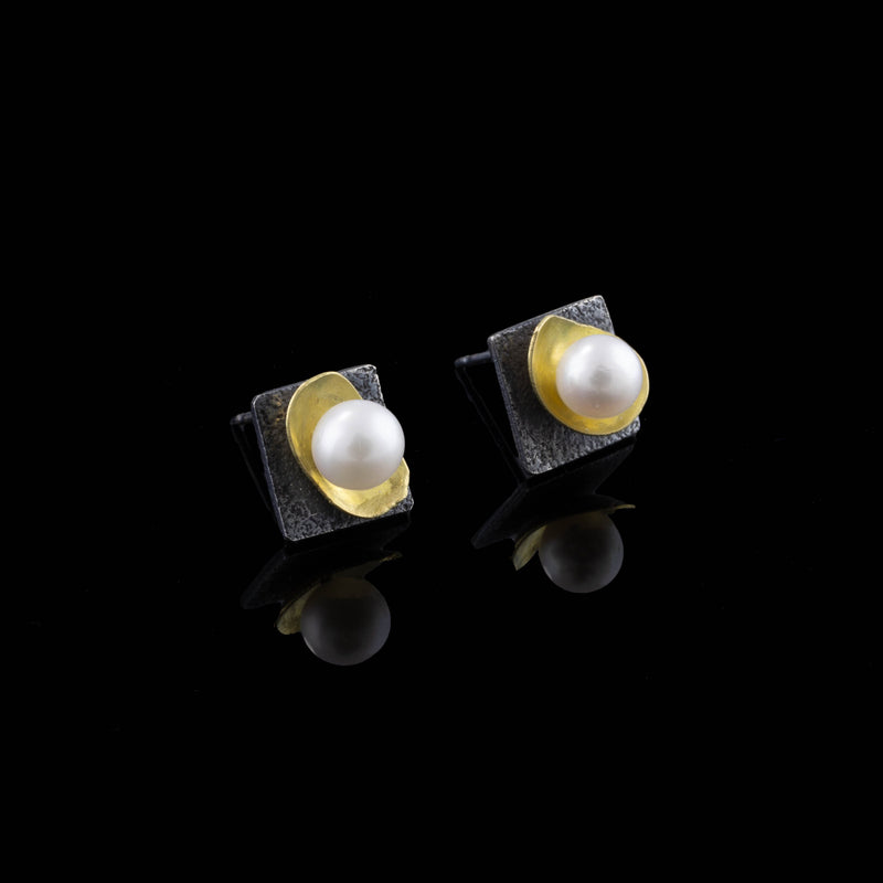 Elegant post earrings handcrafted from oxidized Argentium sterling silver highlighted with freshwater pearls in18K gold cups. 