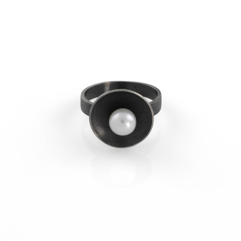 Contemporary design ring handcrafted from oxidized sterling silver with a white freshwater pearl.