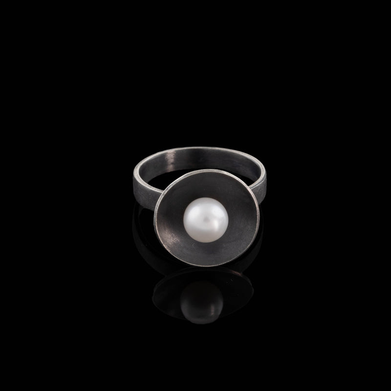 Contemporary design ring handcrafted from oxidized sterling silver with a white freshwater pearl.