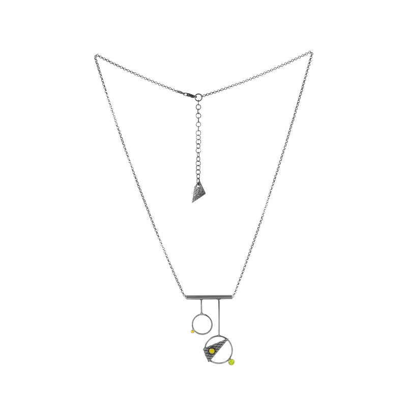 Contemporary, geometric design pendant necklace, handcrafted from oxidized Argentium sterling silver with 18K gold elements and a green peridot set in 18K gold.