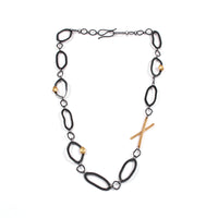 Contemporary, asymmetrical chain necklace, handcrafted in oxidized Argentium sterling silver with 18K gold accents.