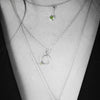 Geometric design pendants, handcrafted with Argentium sterling silver and green peridots set in 18K gold bezels.  Sterling silver chain.