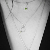 Geometric design pendants, handcrafted with Argentium sterling silver and green peridots set in 18K gold bezels.  Sterling silver chain.