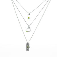 Geometric design pendants, handcrafted with Argentium sterling silver and green peridots set in 18K gold bezels.  Sterling silver chain.