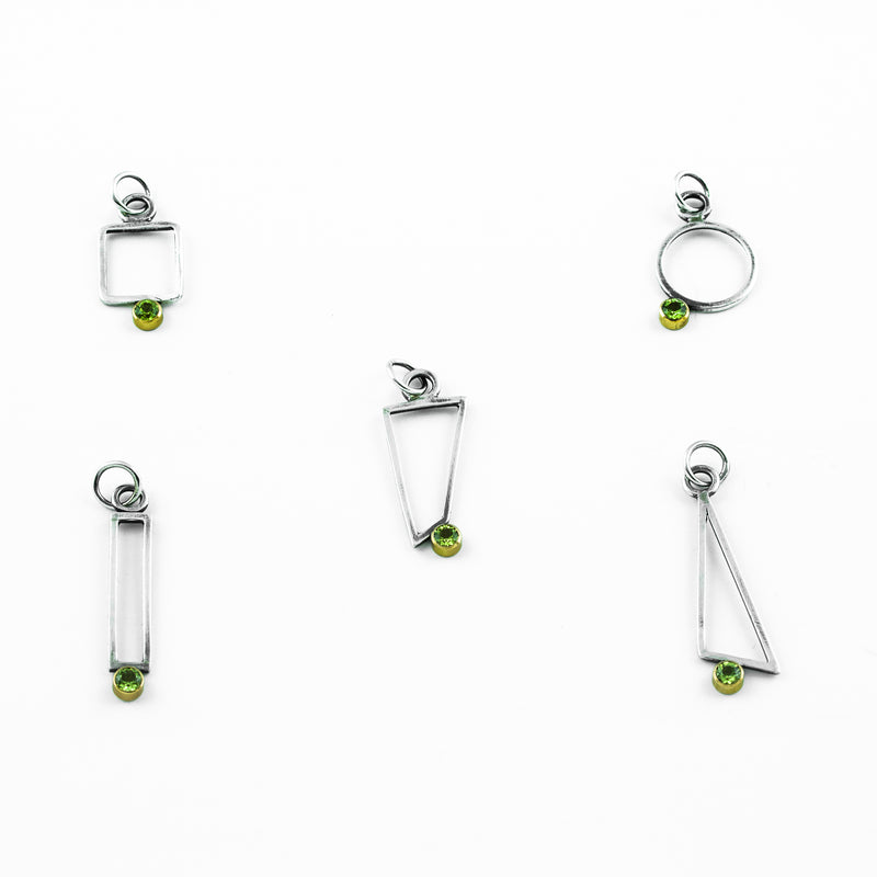 Geometric design pendants, handcrafted with Argentium sterling silver and green peridots set in 18K gold bezels.  Sterling silver chain.