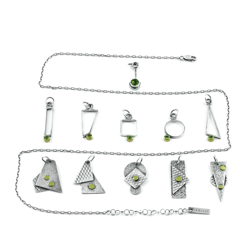 Geometric design pendants, handcrafted with Argentium sterling silver and green peridots set in 18K gold bezels.  Sterling silver chain.