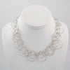 Statement necklace handcrafted from dozens of hammered rings of Argentium sterling silver.