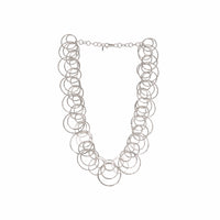 Statement necklace handcrafted from dozens of hammered rings of Argentium sterling silver.