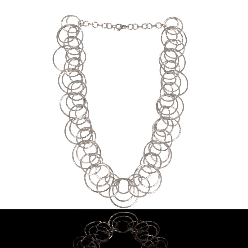 Statement necklace handcrafted from dozens of hammered rings of Argentium sterling silver.