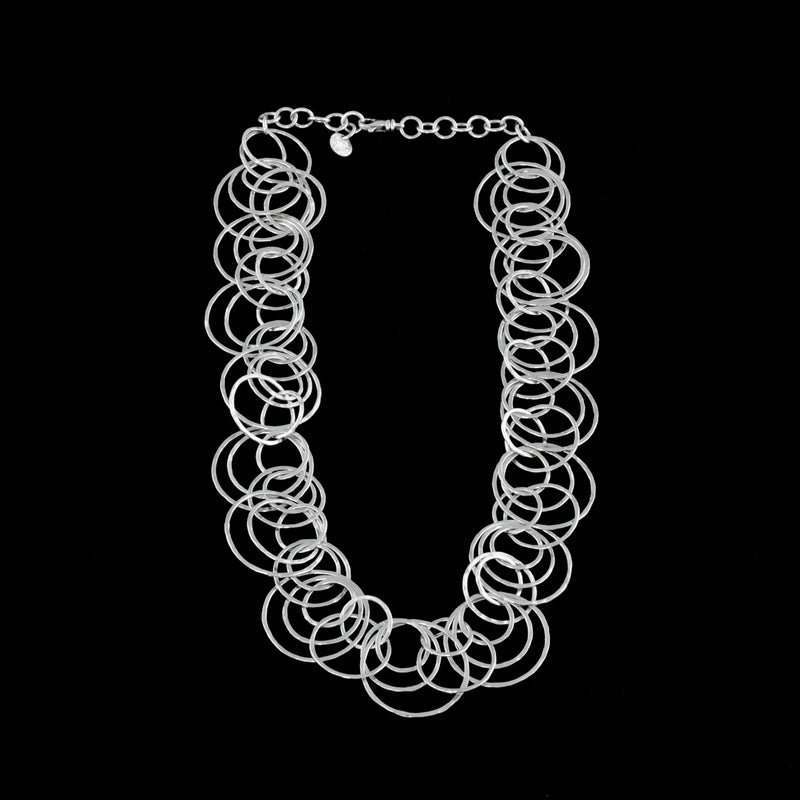 Statement necklace handcrafted from dozens of hammered rings of Argentium sterling silver.