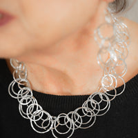 Statement necklace handcrafted from dozens of hammered rings of Argentium sterling silver.