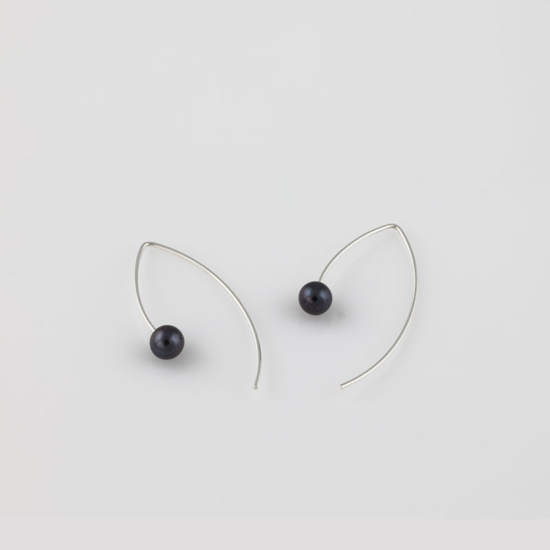 Hand fabricated drop earrings, showcasing black freshwater pearls on Marquise-shaped Argentium sterling silver ear wires.