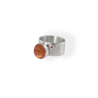 Unique statement ring, handcrafted from Argentium sterling silver and highlighted by a 10mm Oregon sunstone and a rare red sapphire.