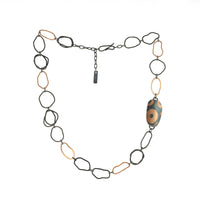 One-of-a-kind statement necklace, hand fabricated from 14K rose gold and Argentium sterling silver links, highlighted by a hollow form element inlaid with pieces of rose gold.