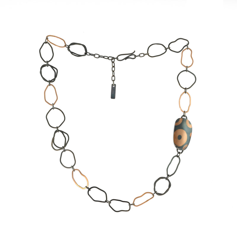 One-of-a-kind statement necklace, hand fabricated from 14K rose gold and Argentium sterling silver links, highlighted by a hollow form element inlaid with pieces of rose gold.