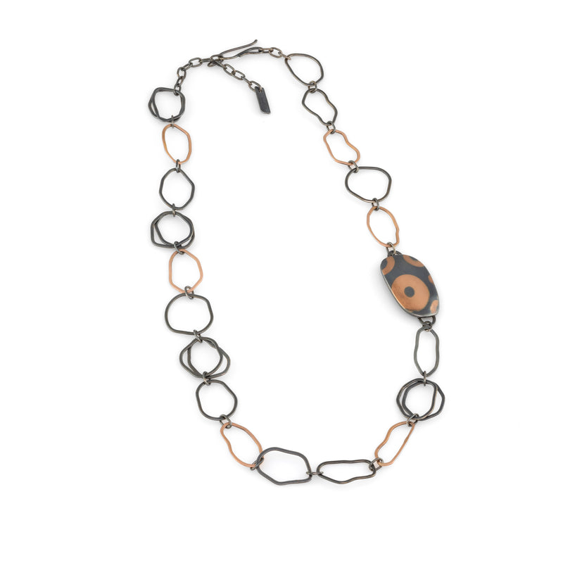 One-of-a-kind statement necklace, hand fabricated from 14K rose gold and Argentium sterling silver links, highlighted by a hollow form element inlaid with pieces of rose gold.